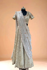 Embroidered cream lehenga choli with matching dupatta on mannequin, luxury Indian ethnic wear
