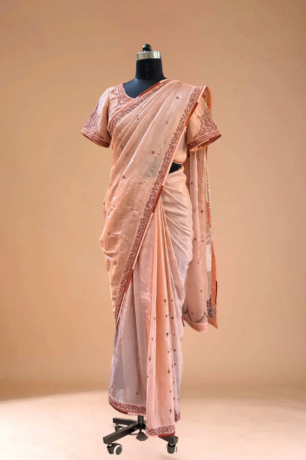 Peach embroidered saree with matching blouse on mannequin, luxury Indian ethnic wear