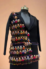 Black designer blazer with vibrant handcrafted doll embroidery, displayed on mannequin