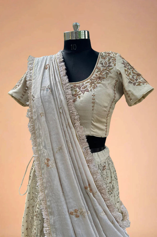 Ivory embroidered Indian lehenga with floral blouse and dupatta on mannequin