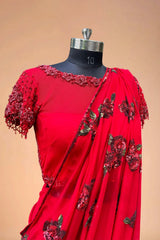 Red designer saree with floral sequins and embroidered blouse on mannequin