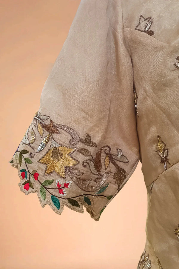 Beige sleeve of Indian designer dress with multicolor floral embroidery and scalloped edge