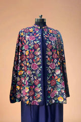 Navy blue blazer with colorful floral embroidery, displayed on mannequin against beige background