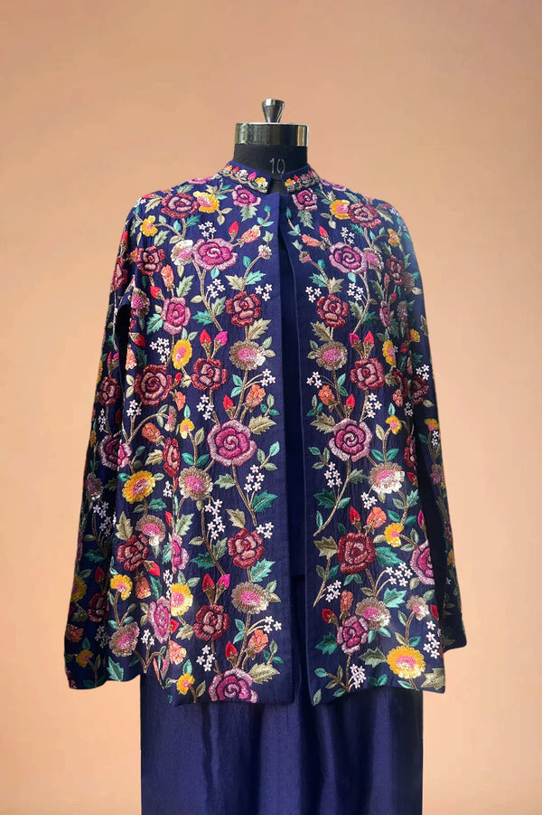 Navy blue blazer with colorful floral embroidery, displayed on mannequin against beige background