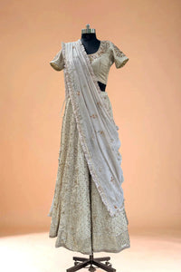 Ivory embroidered lehenga set with blouse and dupatta on mannequin, luxury Indian ethnic wear