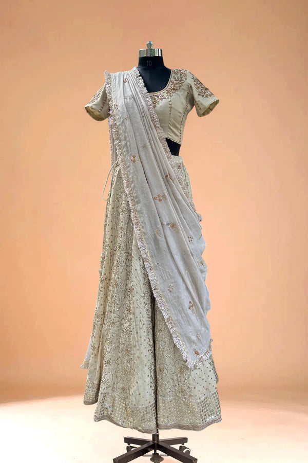 Ivory embroidered lehenga set with blouse and dupatta on mannequin, luxury Indian ethnic wear