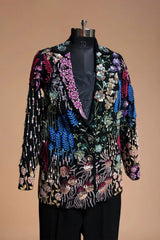 Black blazer with colorful floral embroidery, displayed on mannequin against neutral background