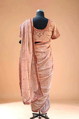 Back view of peach embroidered saree with matching blouse on mannequin, traditional Indian ethnic wear