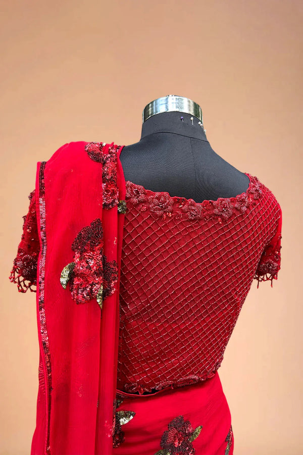 Red embroidered saree blouse with sequin floral border and matching dupatta on mannequin