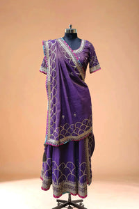 Purple designer lehenga with gold embroidery and matching dupatta on mannequin