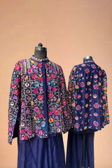 Navy blue designer jackets with vibrant multicolor floral embroidery, displayed on mannequins