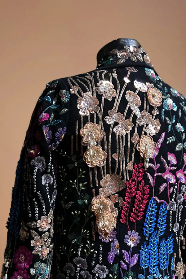 Black blazer with multicolor floral embroidery and sequin embellishments on mannequin