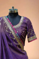 Purple designer saree blouse with gold embroidery and sequin border on mannequin