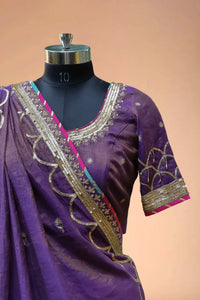 Purple designer saree blouse with gold embroidery and sequin border on mannequin