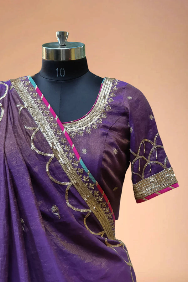 Purple designer saree blouse with gold embroidery and sequin border on mannequin