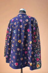 Navy blue blazer with colorful floral embroidery, displayed on a mannequin.