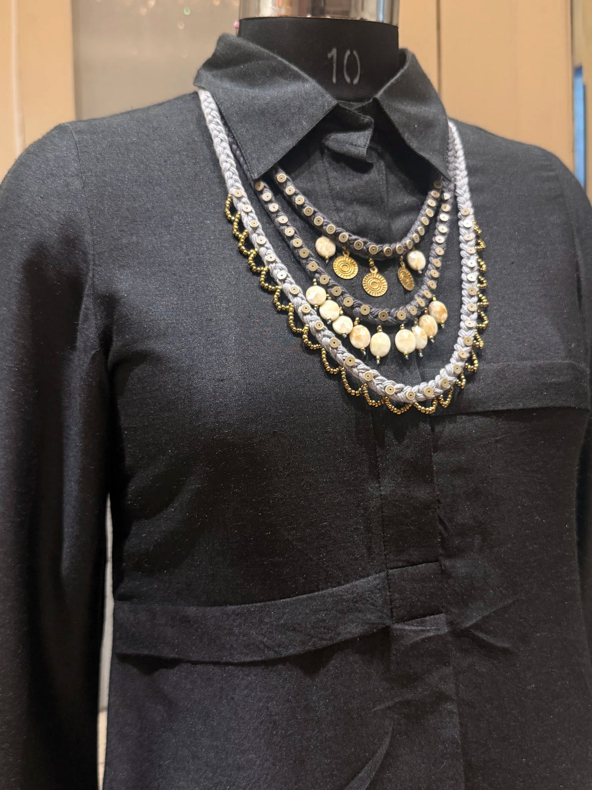 Aavartan handcrafted textile necklace layered necklace on a dark mannequin | Utsavi by Shilpa