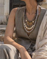 Aavartan handcrafted textile necklace worn with a neutral sari | Utsavi by Shilpa