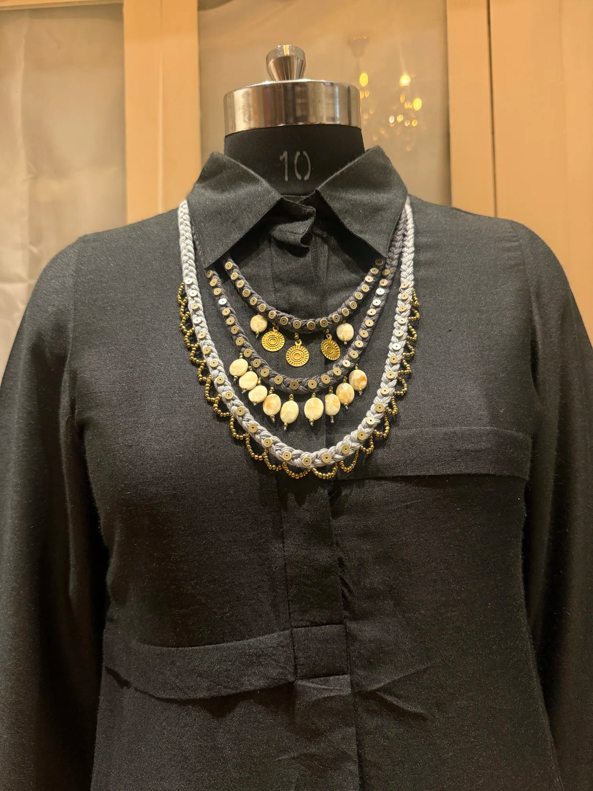 Aavartan handcrafted textile necklace front view on a dark mannequin | Utsavi by Shilpa
