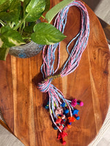 Granthi handcrafted textile necklace colourful braided strands and tassels on wood | Utsavi by Shilpa