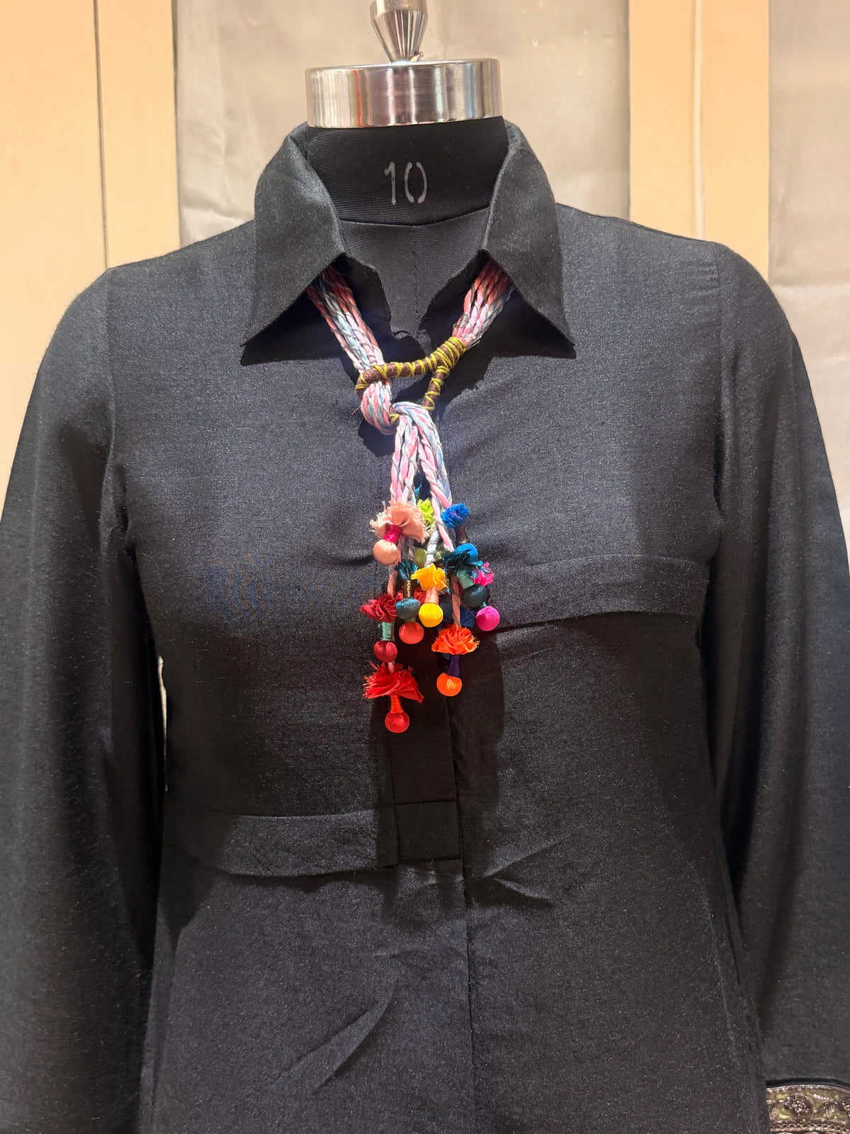 Granthi handcrafted textile necklace displayed on a dark mannequin | Utsavi by Shilpa