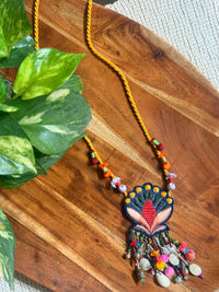 Nisha handcrafted textile necklace floral pendant on a wooden surface | Utsavi by Shilpa