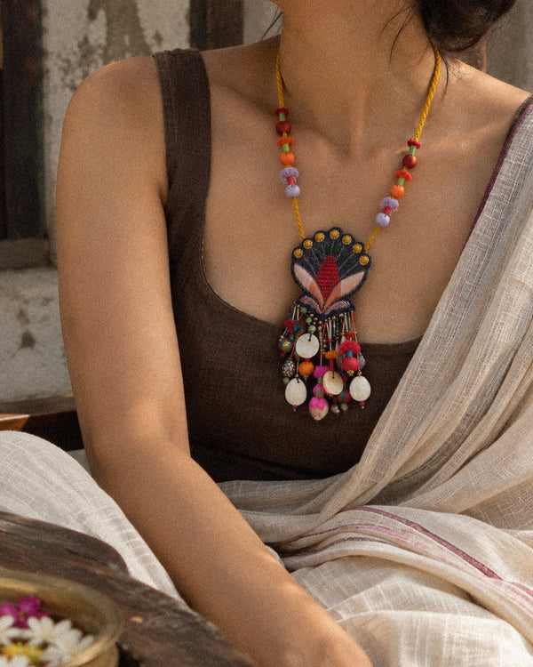 Nisha handcrafted textile necklace pendant detail against a dark background | Utsavi by Shilpa