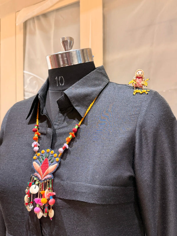 Nisha handcrafted textile necklace displayed on a dark mannequin | Utsavi by Shilpa