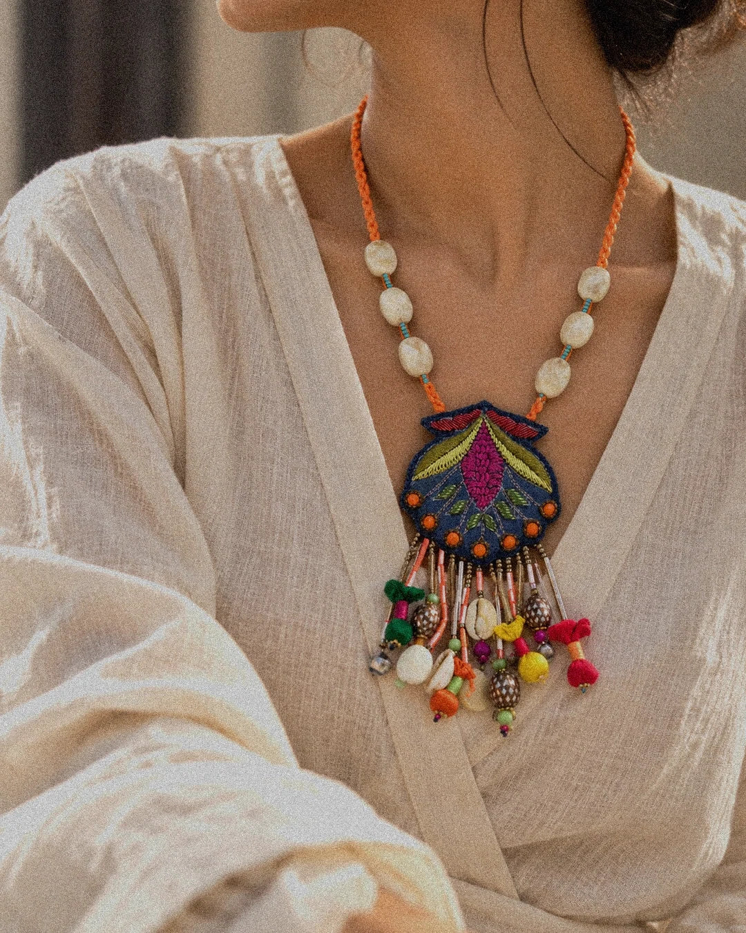 Nisha handcrafted textile necklace worn with a light sari | Utsavi by Shilpa