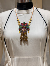 Pallava handcrafted textile necklace pendant displayed over a light garment | Utsavi by Shilpa