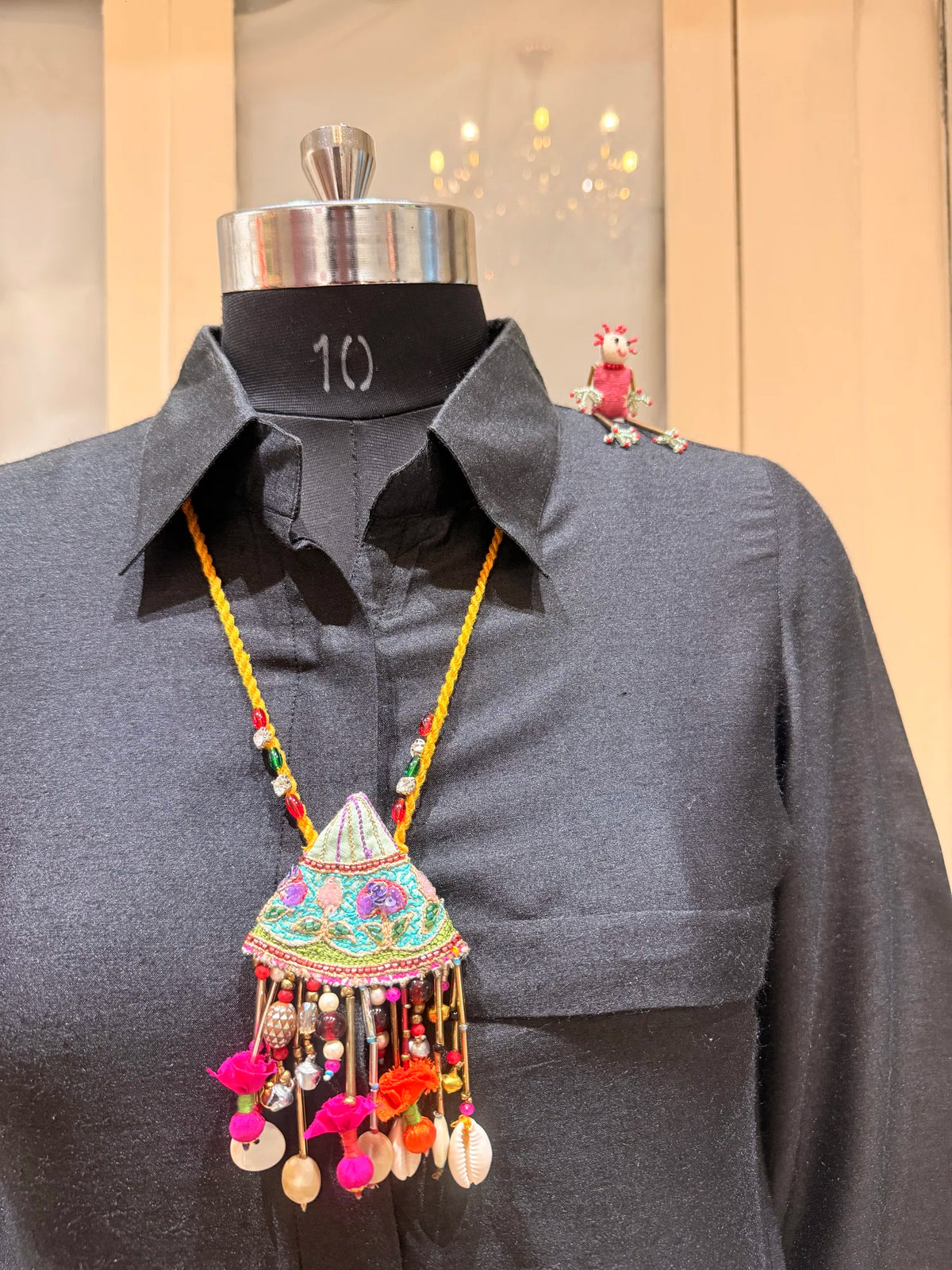 Pallavi handcrafted textile necklace displayed on a dark mannequin | Utsavi by Shilpa