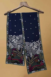 Navy blue pashmina shawl with intricate multicolor floral and botanical embroidery, hanging on a wooden hanger.