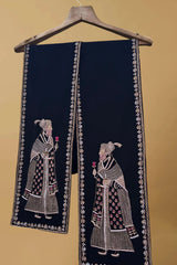 Black pashmina shawl with intricate embroidered figures and floral border on hanger
