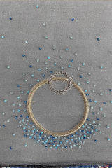 Grey pashmina shawl with blue bead embroidery and gold decorative rings