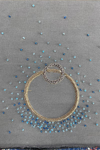Grey pashmina shawl with blue bead embroidery and gold decorative rings