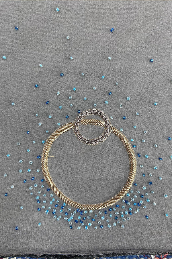 Grey pashmina shawl with blue bead embroidery and gold decorative rings