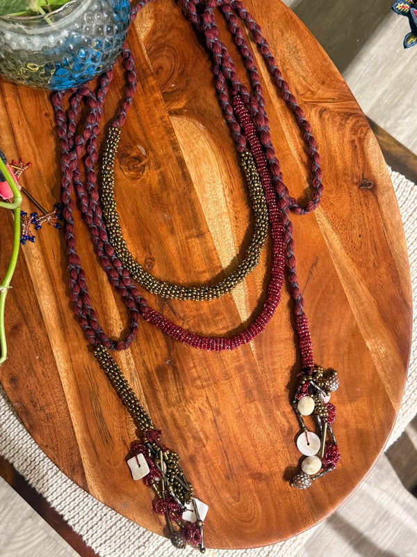 Sangati handcrafted textile necklace textile strands on a wooden surface | Utsavi by Shilpa