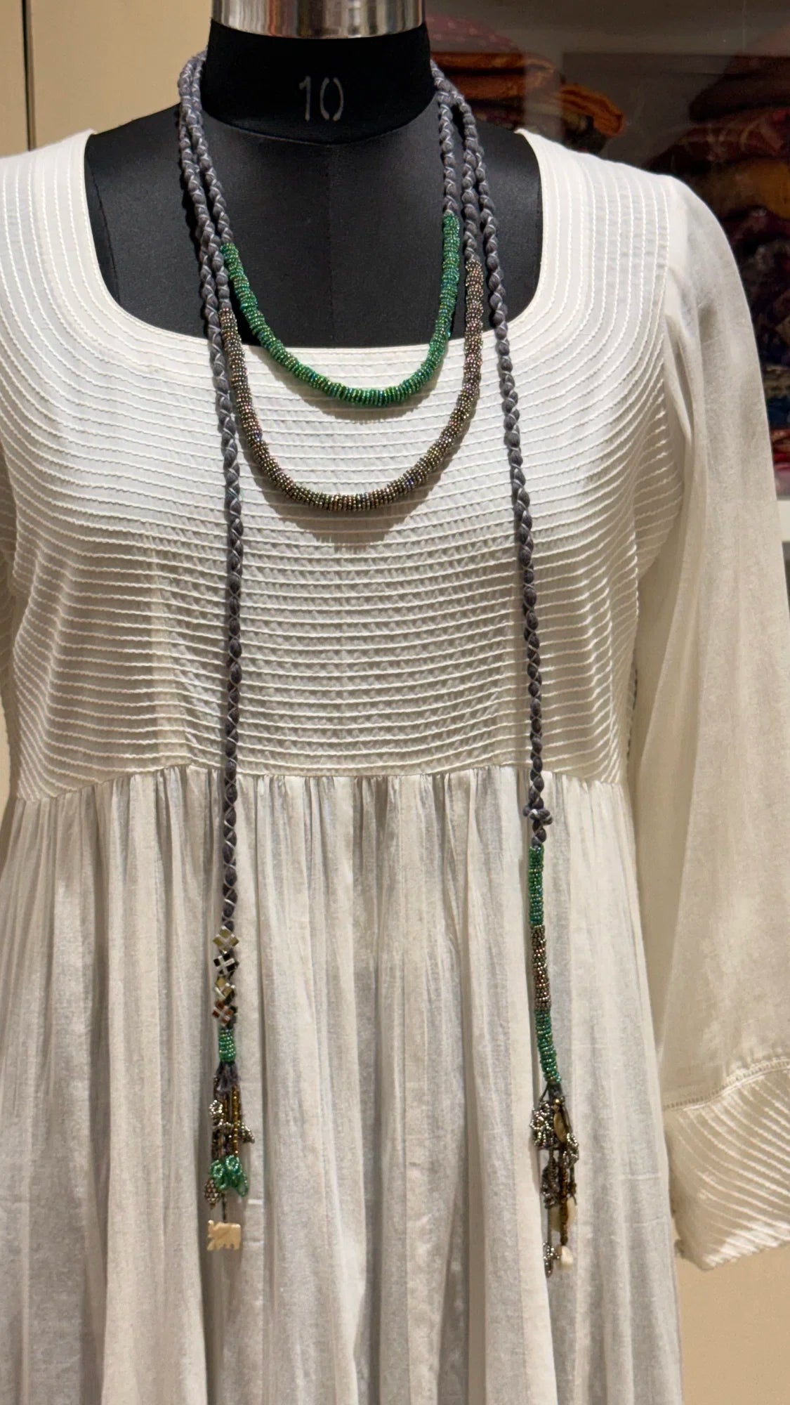 Sangati handcrafted textile necklace long textile necklace displayed over a light garment | Utsavi by Shilpa