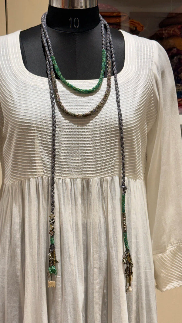 Sangati handcrafted textile necklace long textile necklace displayed over a light garment | Utsavi by Shilpa