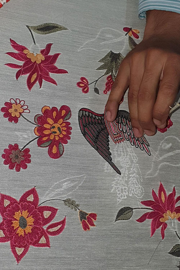 Hand embroidering designer floral and bird motif on luxury ethnic fabric