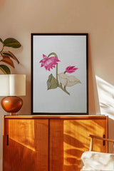 Minimalist wall art with pink lotus flowers, framed above wooden cabinet in modern living room
