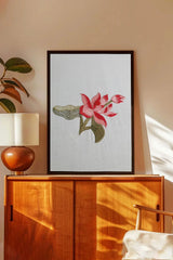 Framed wall art with embroidered pink lotus flower and green leaves in a modern living room