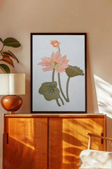 Framed lotus flower embroidered wall art above a wooden cabinet in a modern living room